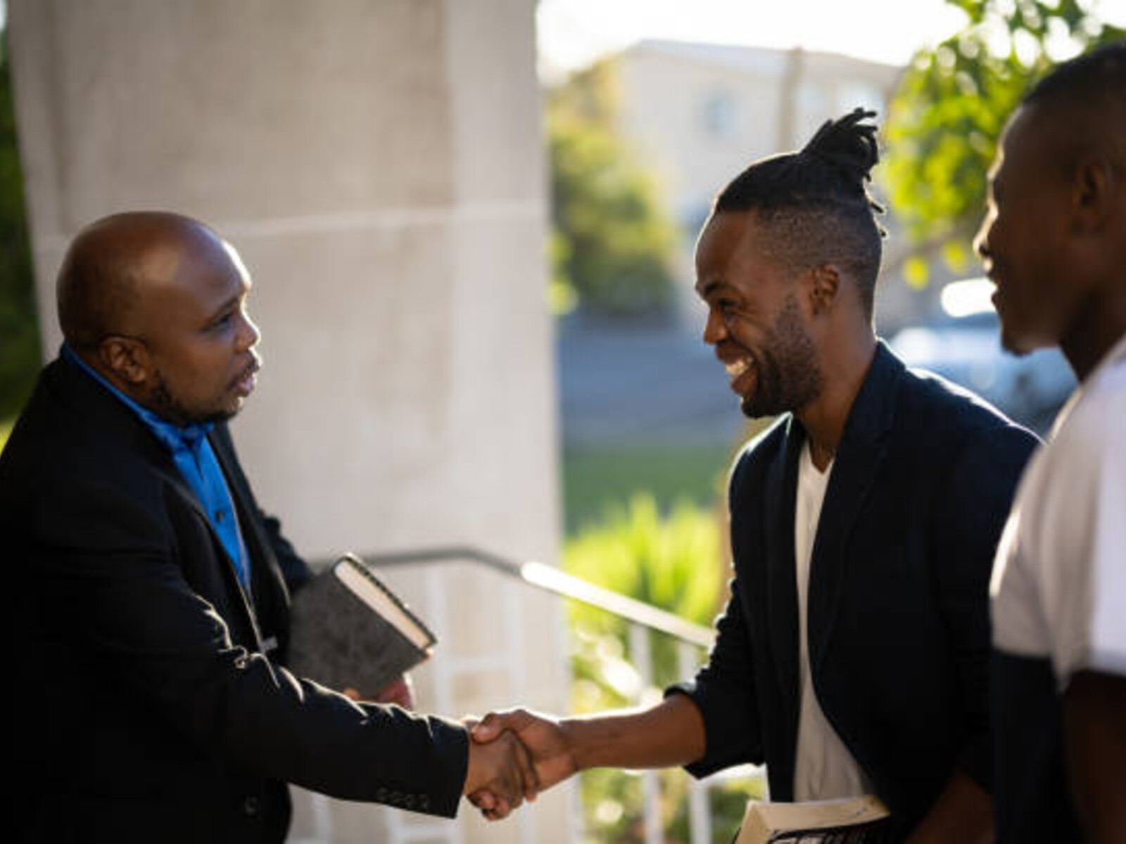 Pastor greeting members at the church doors