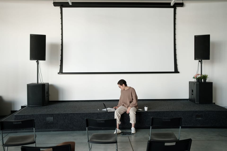 A projector throwing a slide onto a screen